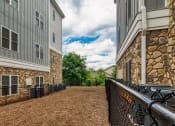 Thumbnail 8 of 35 - the preserve at ballantyne commons apartments courtyard and stone building