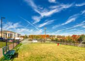 Thumbnail 4 of 53 - a park with a red fire hydrant in the middle of a fieldat Blue Ridge Commons Apartments, Roanoke, Virginia
