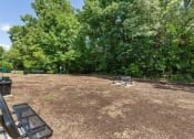 Thumbnail 40 of 43 - a picnic area with a grill and benches in a park at Village 1373, Greensboro