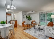 Thumbnail 9 of 22 - an open living room with a kitchen and a sliding glass door