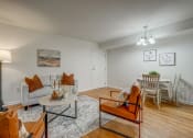 Thumbnail 6 of 22 - an open living room and dining room with a table and chairs