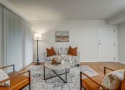 Thumbnail 7 of 22 - a living room with a couch and a table