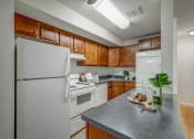 Thumbnail 1 of 22 - an updated kitchen with white appliances and wood cabinets