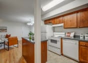 Thumbnail 3 of 22 - a kitchen with white appliances and wooden cabinets