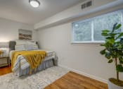 Thumbnail 11 of 22 - a bedroom with a bed and a large window