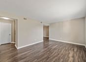 Thumbnail 5 of 21 - a bedroom with hardwood floors and white walls