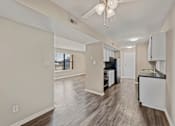 Thumbnail 6 of 21 - a kitchen and living room with a ceiling fan