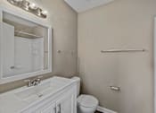 Thumbnail 9 of 21 - a bathroom with a sink toilet and mirror