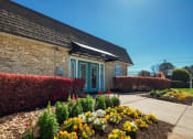 Thumbnail 3 of 52 - the front of a brick building with a flower garden  at Bayville Apartments, Virginia, 23455