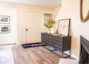 Thumbnail 4 of 31 - A room with a wooden floor and a white door.