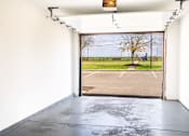 Thumbnail 16 of 31 - A view of an open gate leading to a parking lot.