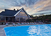 Thumbnail 30 of 31 - A swimming pool in front of a house.