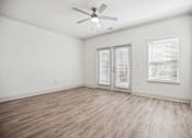 Thumbnail 23 of 56 - A room with a ceiling fan and wooden flooring.