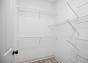 Thumbnail 28 of 56 - Empty white shelves in a room.