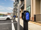 Thumbnail 24 of 38 - a parking meter with a white car parked in front of a building at Aura Stonebridge, Richmond, 23225