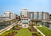 Thumbnail 18 of 42 - A large building with a pool in front of it.