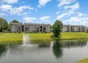 Thumbnail 41 of 43 - a fountain in the pond with an apartment building in the background at Village 1373, North Carolina
