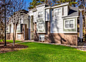 Thumbnail 64 of 67 - A row of houses with a green lawn in front.