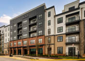 Thumbnail 14 of 38 - an exterior view of an apartment building on a city street at Aura Stonebridge, Richmond, VA