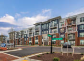 Thumbnail 30 of 42 - an exterior view of an apartment building on a city street at The Bella at Westchester, Virginia