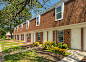 Thumbnail 24 of 26 - A row of houses with white doors and windows.