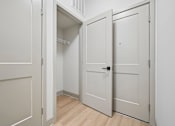 Thumbnail 46 of 59 - A white door is open to a small closet.