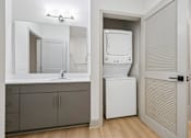 Thumbnail 42 of 59 - A bathroom with a white sink and a white cabinet.