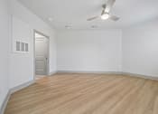 Thumbnail 40 of 59 - A room with a ceiling fan and wooden flooring.