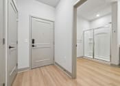 Thumbnail 44 of 59 - A white door with a black handle is in a room with wood flooring.
