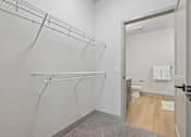 Thumbnail 30 of 59 - A white bathroom with a walk in shower and a towel hanging on the door.