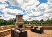 Thumbnail 7 of 35 - the patio has a stone fireplace and furniture on it