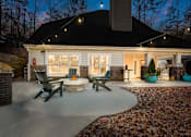 Thumbnail 60 of 67 - A house with a patio and a fire pit.