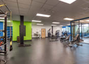 Thumbnail 40 of 46 - a large fitness room with cardio machines and weights at The Hudson, Richmond, 23224