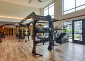 Thumbnail 63 of 81 - a gym with weights and exercise equipment and windows at Ainsworth, Richmond