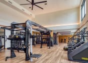 Thumbnail 4 of 81 - a gym with treadmills and other exercise equipment on a wood floor at Ainsworth, Richmond