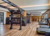Thumbnail 58 of 81 - a gym with weights and cardio equipment on the floor and a window at Ainsworth, Virginia, 23228