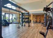 Thumbnail 60 of 81 - a gym with cardio equipment and weights on a wooden floor at Ainsworth, Virginia, 23228
