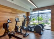 Thumbnail 5 of 81 - a gym with treadmills and other exercise equipment in the lobby of a building at Ainsworth, Richmond