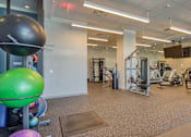 Thumbnail 65 of 88 - A gym with a variety of equipment including a green exercise ball.