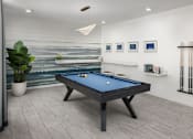 Thumbnail 15 of 42 - A pool table in a room with a painting on the wall.