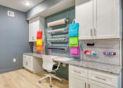 Thumbnail 39 of 42 - a home office with white cabinets and a desk with a chair at The Bella at Westchester, Midlothian, 23113