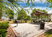 Thumbnail 19 of 21 - A park with a pavilion, benches, and a trash can.