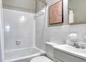 Thumbnail 11 of 15 - a white bathroom with a tub and a sink and a toilet
