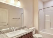 Thumbnail 34 of 35 - a bathroom with a shower sink and toilet and a mirror