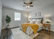 Thumbnail 14 of 32 - a bedroom with a bed and a ceiling fan