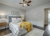Thumbnail 13 of 32 - the master bedroom has a comfy bed and a ceiling fan