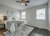 Thumbnail 11 of 32 - a bedroom with a bed and a ceiling fan