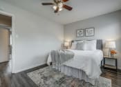 Thumbnail 10 of 32 - a bedroom with a bed and a ceiling fan