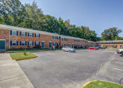 Thumbnail 29 of 32 - an empty parking lot in front of a brick building