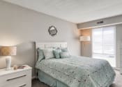 Thumbnail 26 of 52 - a bedroom with a bed and a window  at Bayville Apartments, Virginia Beach, Virginia